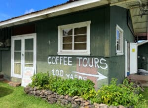 green building hawaiii with coffee tours sign