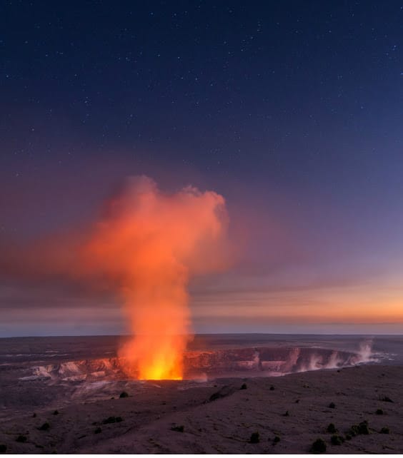 Red glow of lava in volcanic crater at Volcanoes National Park