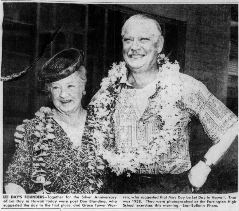 Two people wearing leis.