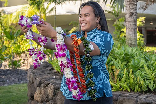 Woman holding a lei.
