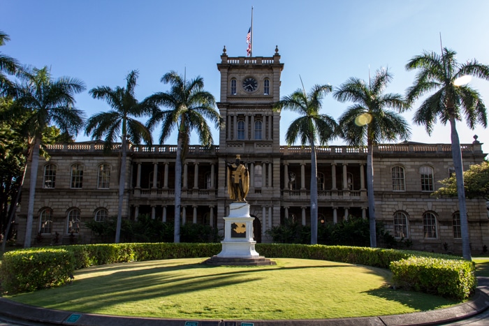 large building in hawaiii with statue in front